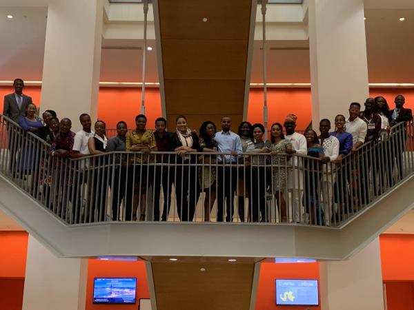 Image of the Mandela Fellows standing on the Lebow Staircase looking down at the camera.